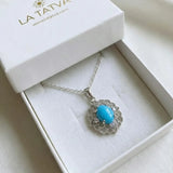 Silver necklace with a Turquoise pendant in a white box, featuring the brand 'La Tatva'.